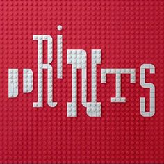 the letters are made out of legos and have white letters on red background that spell out their names