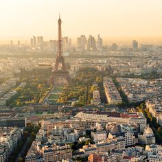 the eiffel tower towering over the city of paris, france in the sunset