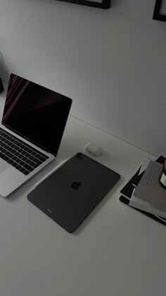 an open laptop computer sitting on top of a white desk next to a cup of coffee