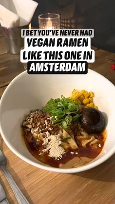 a white bowl filled with food on top of a wooden table