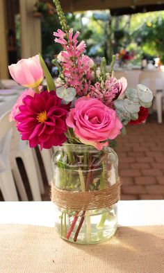 a vase filled with flowers sitting on top of a table