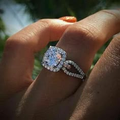 a woman's hand with a ring on it and an engagement band around her finger