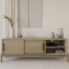 a living room scene with focus on the sideboard and vases in the background