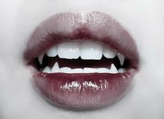 a woman's mouth with white teeth and red lipstick