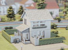 a model of a house in the middle of a yard