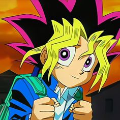 an anime character with blonde hair and big eyes holding a green object in his hand