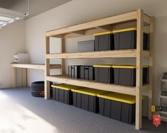 there is a shelf with many bins on it in the room next to some shelves