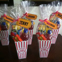 three popcorn buckets filled with candy and candies