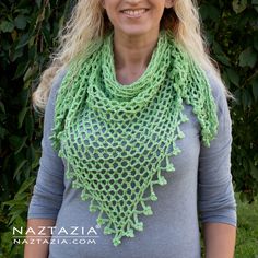 a woman wearing a green crocheted scarf