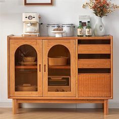 a wooden cabinet with glass doors and shelves on the top, holding various kitchen utensils