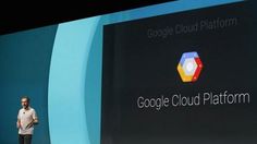 a man standing in front of a large screen with google cloud platform logo on it