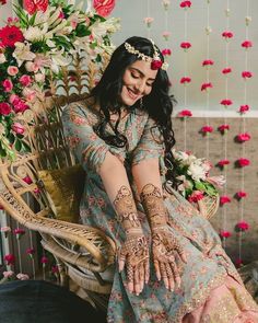 a woman sitting on top of a chair with her hands covered in hendikes