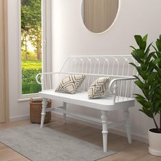 a white bench sitting next to a potted plant