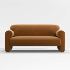 a brown couch sitting on top of a white floor