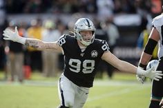 a football player with his arms out in the air