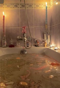 a bathtub filled with water and candles