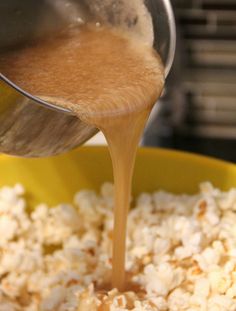 a yellow bowl filled with popcorn being poured into it