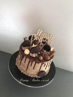 a birthday cake with chocolate frosting and decorations