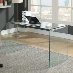 a glass desk with a laptop on it