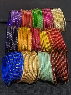 A set includes 12 bangles. Base material is made of aluminium and then color coated with gold glitter. Available in Inner Diameter: 2.25, 2.37, 2.5 inches. 2.25 inches is commonly referred as 2x4 Indian size. 2.37 inches is commonly referred as 2x6 Indian size. 2.5 inches is commonly referred as 2x8 Indian size. Please allow some variation in color. Match your outfits with these colorful trendy bangles. Please note: Excess glitter will fall off after couple of use. Do not expose to water. Bangles Aesthetic, Indian Bridal Bangles, Wedding Return Gifts, Diy Hair Accessories Tutorial, Accessories Tutorial, Bangle Ceremony, Stunning Rings, Hair Accessories Tutorial, Jewellery Bangles