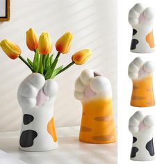 a vase with yellow tulips in it sitting on a table