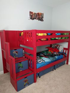 a red bunk bed with blue drawers underneath it in a child's playroom