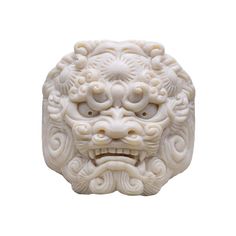 a white carved head on a white background