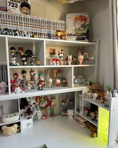 a room filled with lots of different types of figurines on top of bookshelves