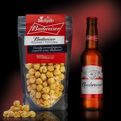 a bottle of budweiser beer next to a bag of gourmet popcorn