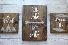 three wooden signs that say run wild, dream big and be brave with arrows on them