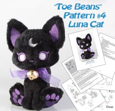 a stuffed animal cat with purple eyes and ears sitting next to instructions for how to make it