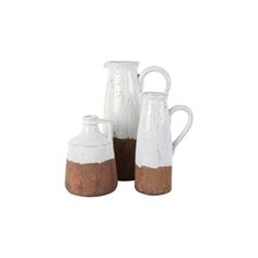 three white and brown vases sitting next to each other