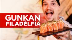 a man holding a tray with sushi on it and the caption gunkan filadefia