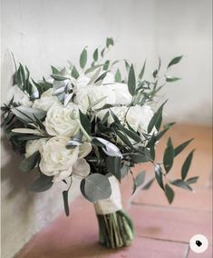 a bouquet of white flowers sitting on top of a table