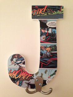 the letter j is made up of comic panels and metal hooks, along with an iron hook