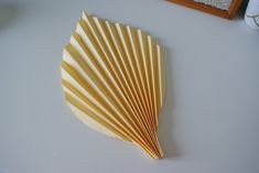 a close up of a paper fan on a table