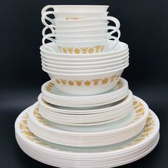 a stack of white plates sitting on top of each other