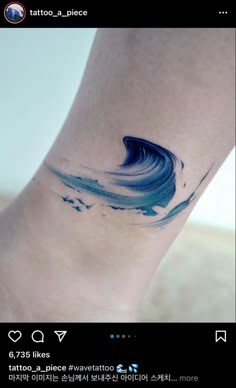 a small wave tattoo on the ankle