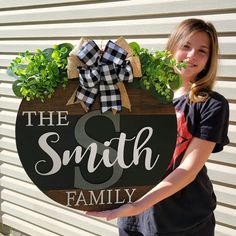 "This custom made family door sign is a great and unique way to personalize your family front door! This sign makes a perfect gift for weddings, housewarmings, anniversaries, etc! How it's made: This door sign is made of 1/2\" plywood.  Each piece is then hand painted, and glued onto hanger. Handmade bow and greenery are attached with heavy duty staples. Sign sizes are approximately 15\" x 15\", 18\"x18\", 20\"x20\", and 22\"x22\" . Exterior lacquer is applied to the finished product to help ext Last Name Door Hanger, Initial Door Hanger, Last Names, Wood Wreath, Raised Letters, Door Signs Diy, Going Out Of Business, Custom Door, Handmade Bows