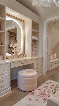 a dressing room with white furniture and drawers