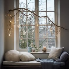 a window sill with lights hanging from it's sides and pillows on the windowsill