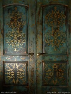 an ornately painted wooden door with gold and blue paint on the doors, which are decorated