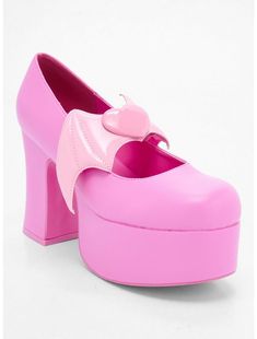 a pink platform shoe with a heart on the front and bow at the back,