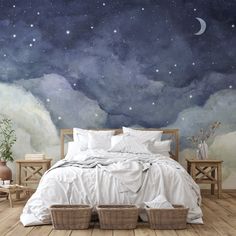 a large bed sitting under a night sky mural