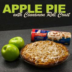 an apple pie with cinnamon roll crust next to green apples and a can of cinnamon rolls