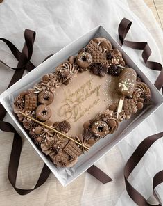 a birthday cake in a box with chocolate decorations