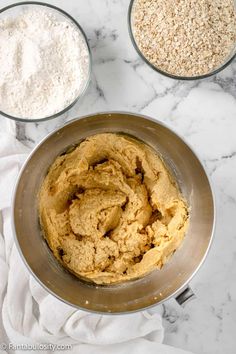 the ingredients to make oatmeal are in bowls on top of a marble counter