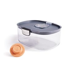 a plastic container with an orange lid next to it