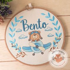 a teddy bear is sitting on top of an airplane with the word bento in it