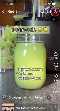 a jar filled with green liquid sitting on top of a counter